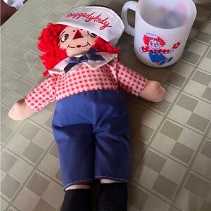 Vintage Raggedy Andy doll. Vintage Milk glass mug.